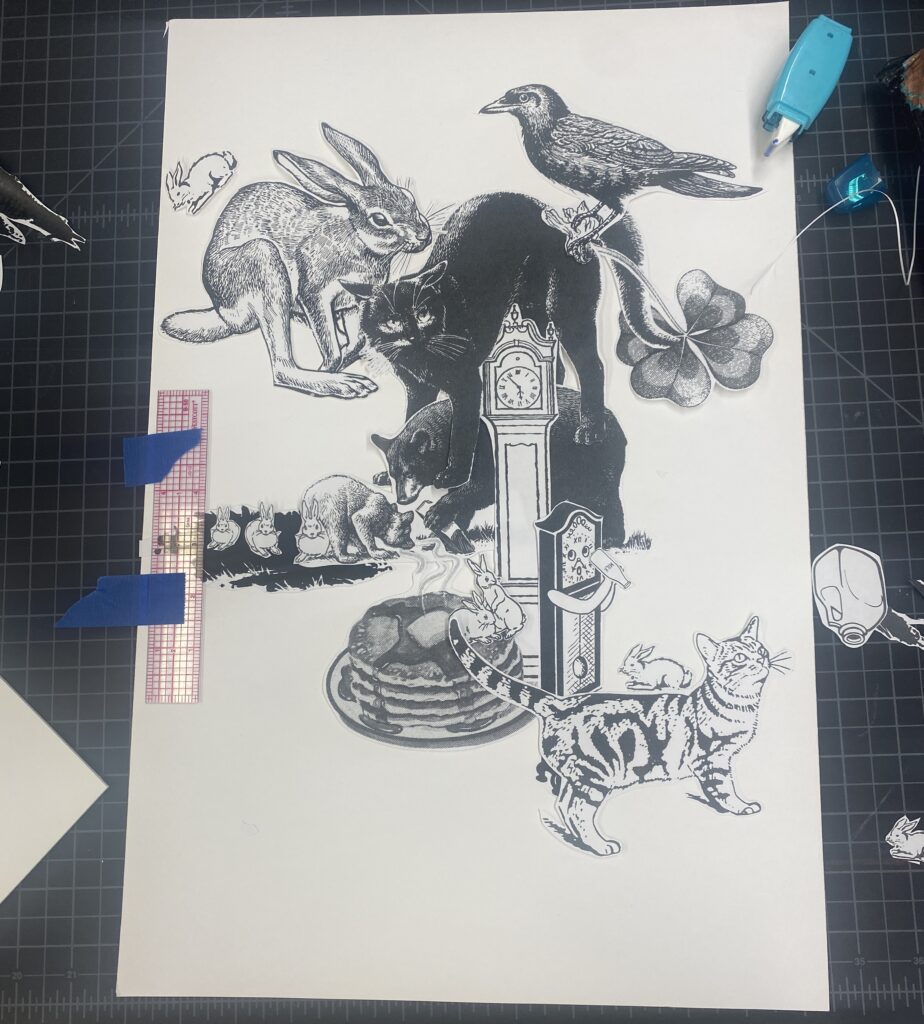 A collage in progress containing black and white drawn imagery of cats, rabbits, clocks, bears, a stack of pancakes, a crow, and a four leaf clover.